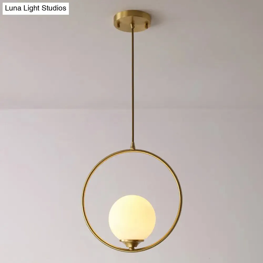 Minimalist Antique Gold Ball Ceiling Lamp with Cream Glass Shade and Ring Decoration